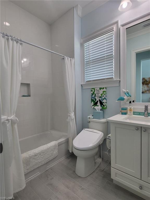8770 Calypso Court Naples, FL 34113 - Photo 31 of 47 a bathroom with a sink toilet and shower