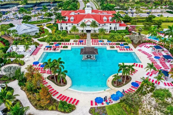 a view of a swimming pool with lawn chairs and a yard
