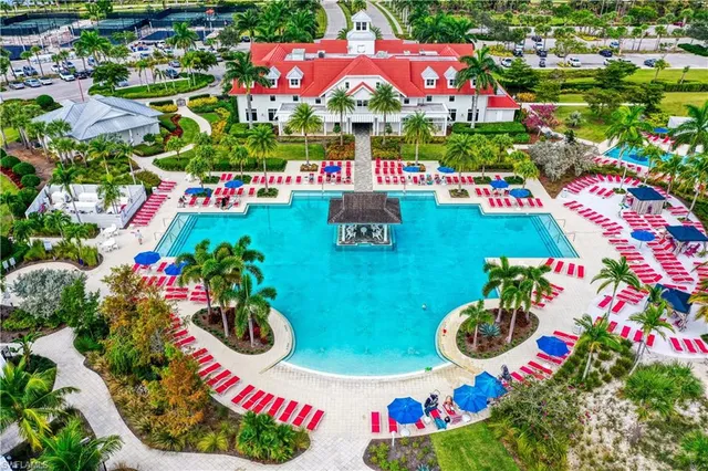 a view of a swimming pool with lawn chairs and a yard