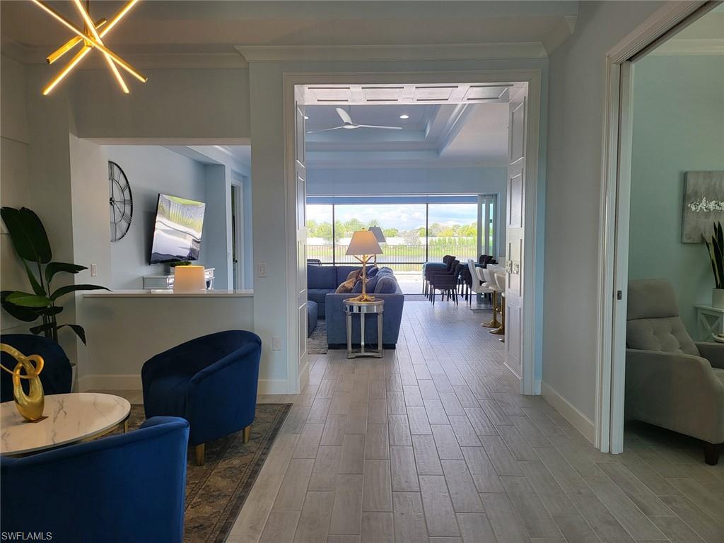 8770 Calypso Court Naples, FL 34113 - Photo 4 of 47 a living room with furniture and a wooden floor