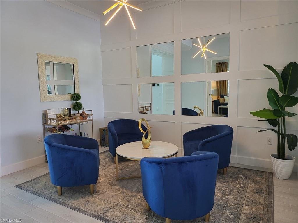 8770 Calypso Court Naples, FL 34113 - Photo 5 of 47 a living room with furniture and a potted plant