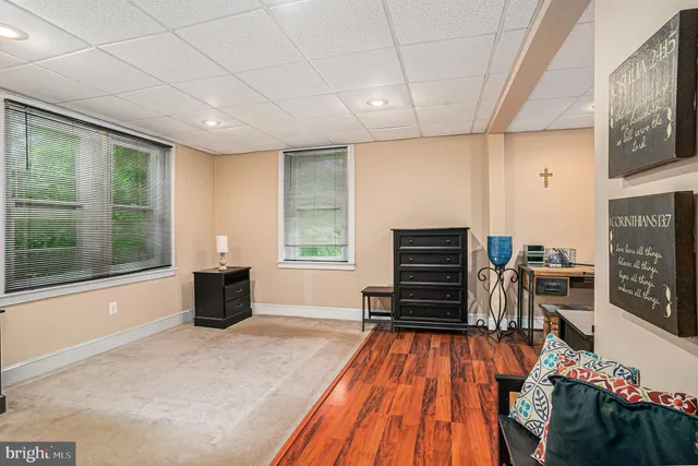 a spacious bedroom with a bed and a dresser