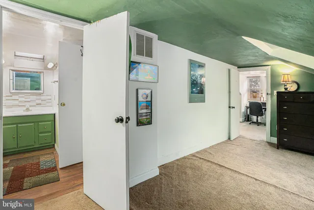 a bedroom with a bed and a mirror