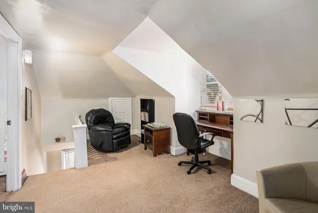 a living room with furniture and a piano