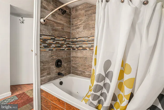 a bathroom with a tub and shower