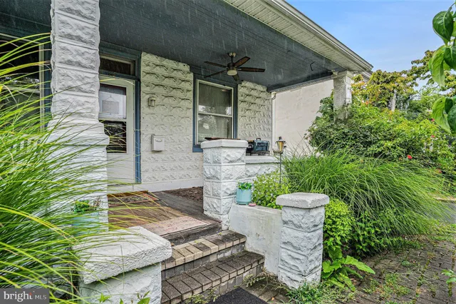a view of a patio with table and chairs and potted plants