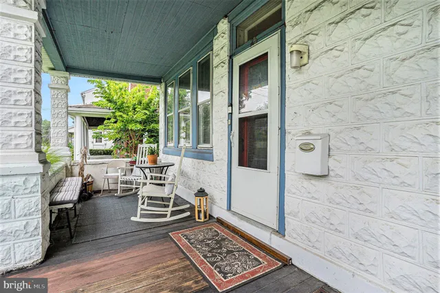 a living room with fireplace furniture and a floor to ceiling window