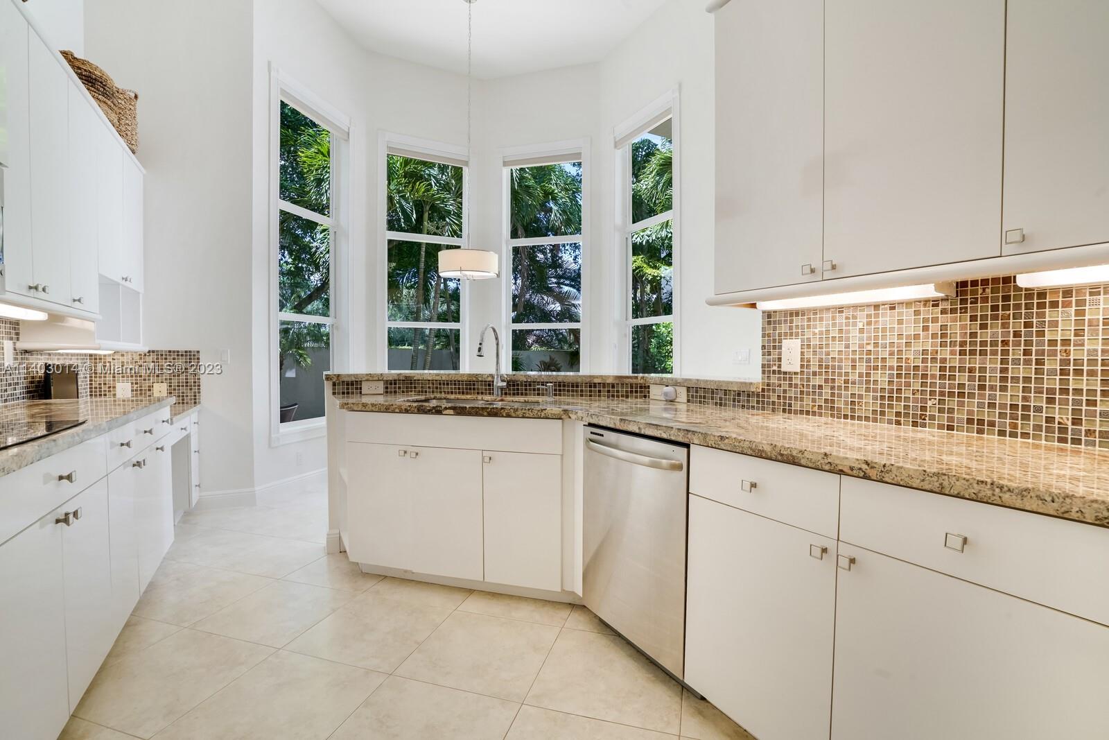 3322 Northwest 53rd Circle Boca Raton, FL 33496 - Photo 15 of 45 a kitchen with granite countertop white cabinets and a sink