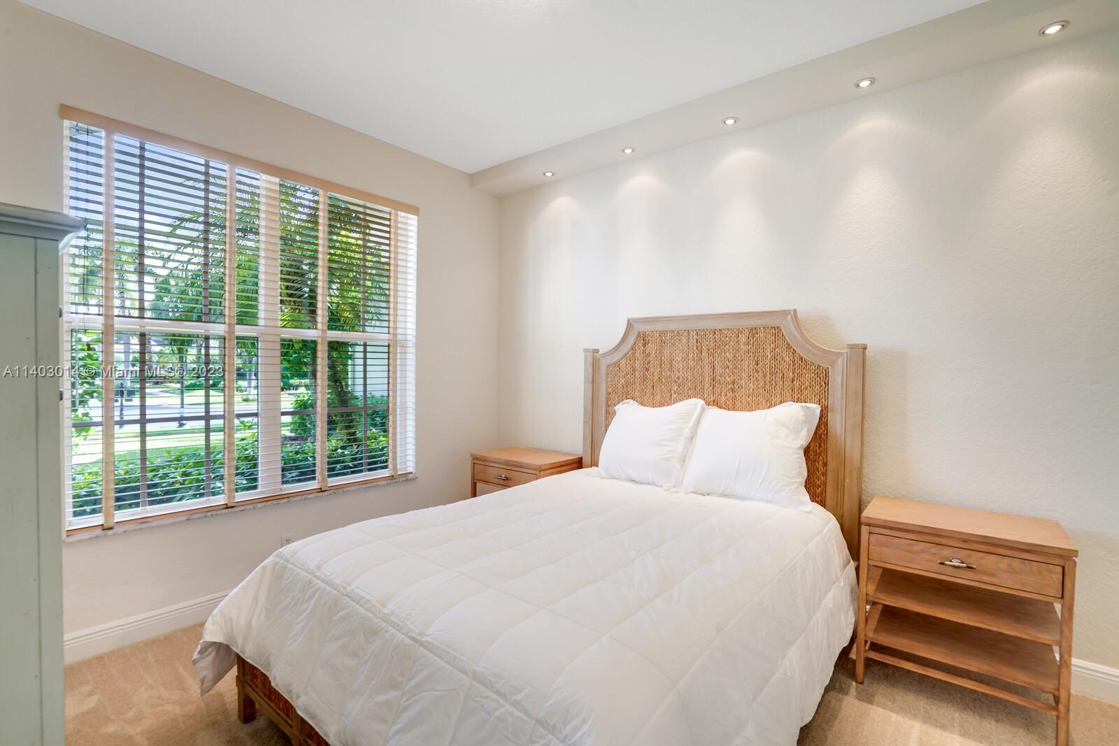 3322 Northwest 53rd Circle Boca Raton, FL 33496 - Photo 16 of 45 a bedroom with a bed and a window