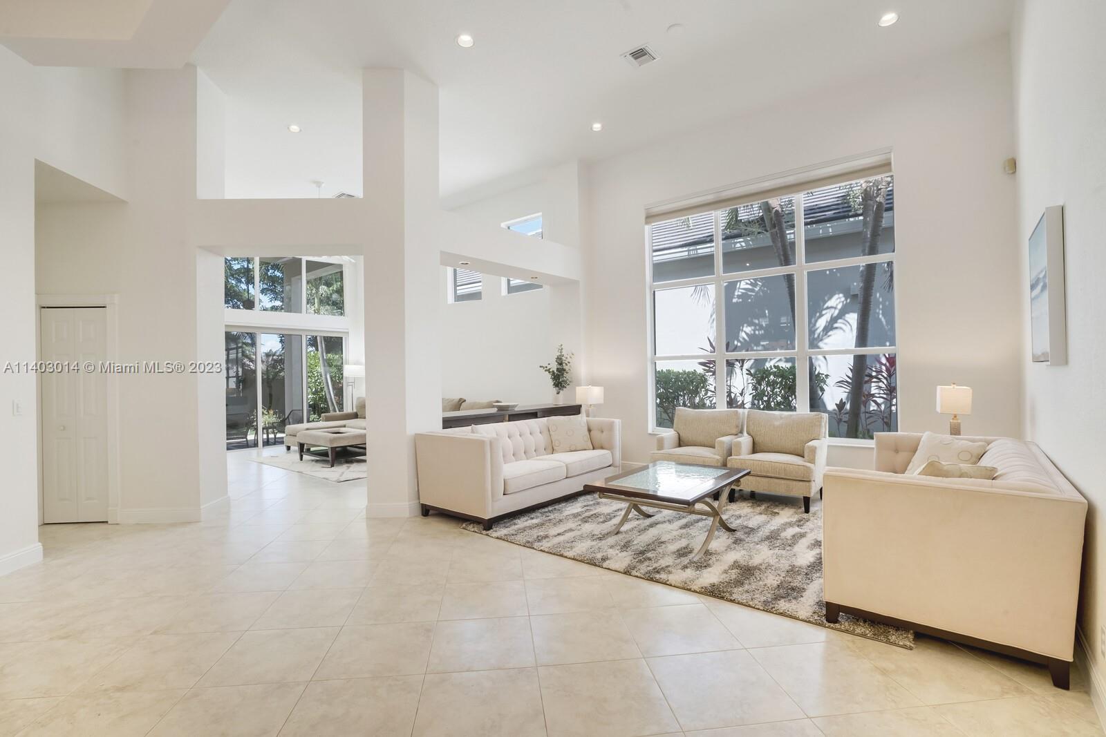 3322 Northwest 53rd Circle Boca Raton, FL 33496 - Photo 2 of 45 a living room with furniture and a large window