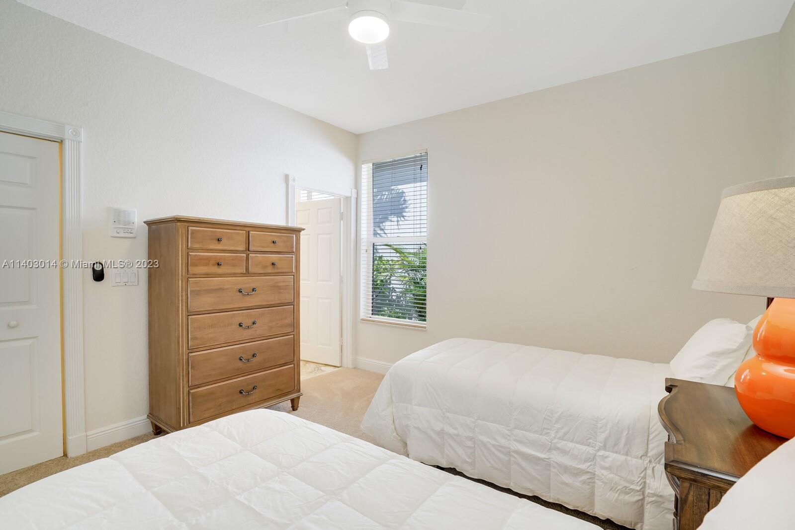 3322 Northwest 53rd Circle Boca Raton, FL 33496 - Photo 21 of 45 a bedroom with a bed and a dresser