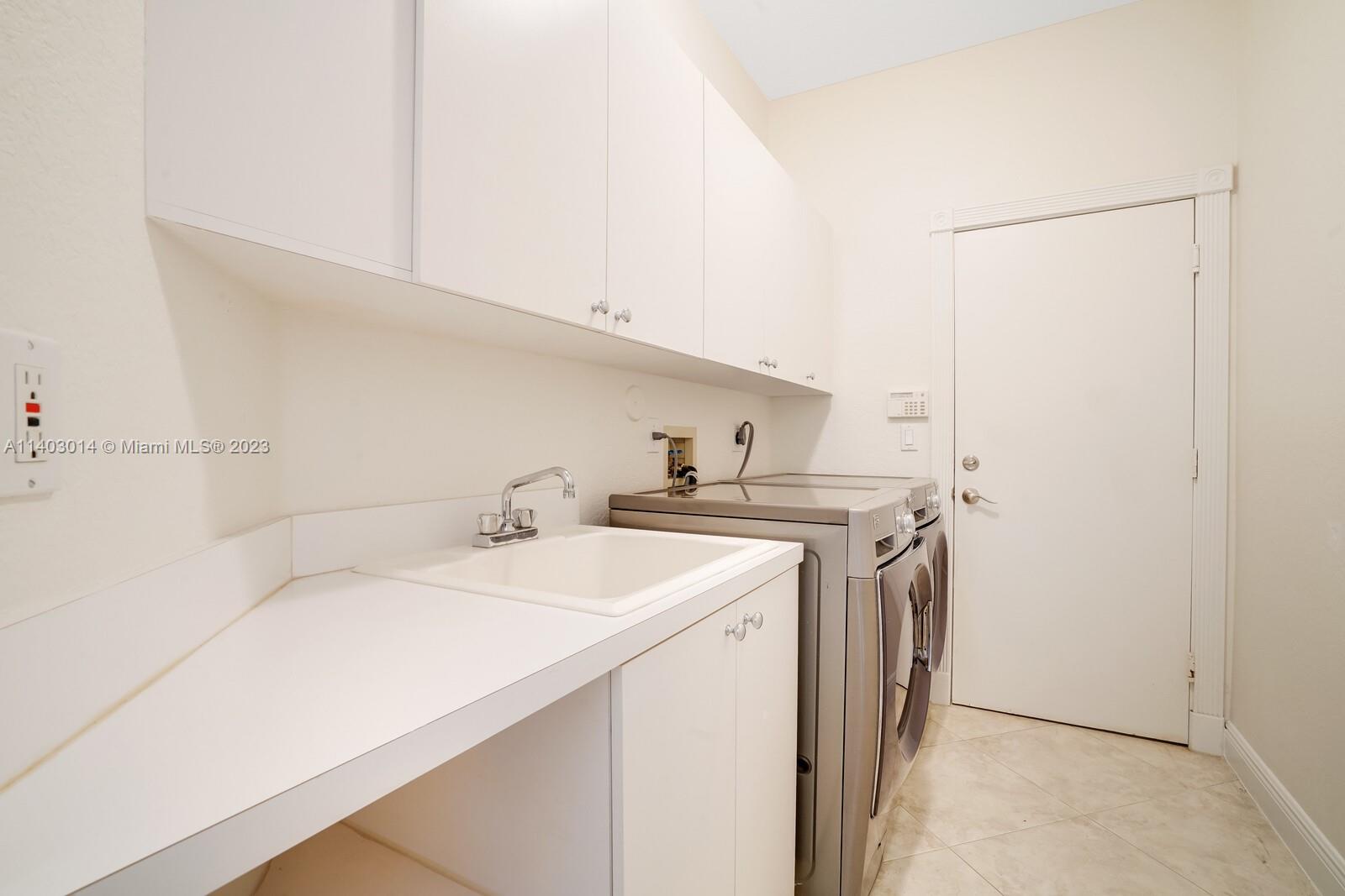 3322 Northwest 53rd Circle Boca Raton, FL 33496 - Photo 27 of 45 a utility room with dryer and washer