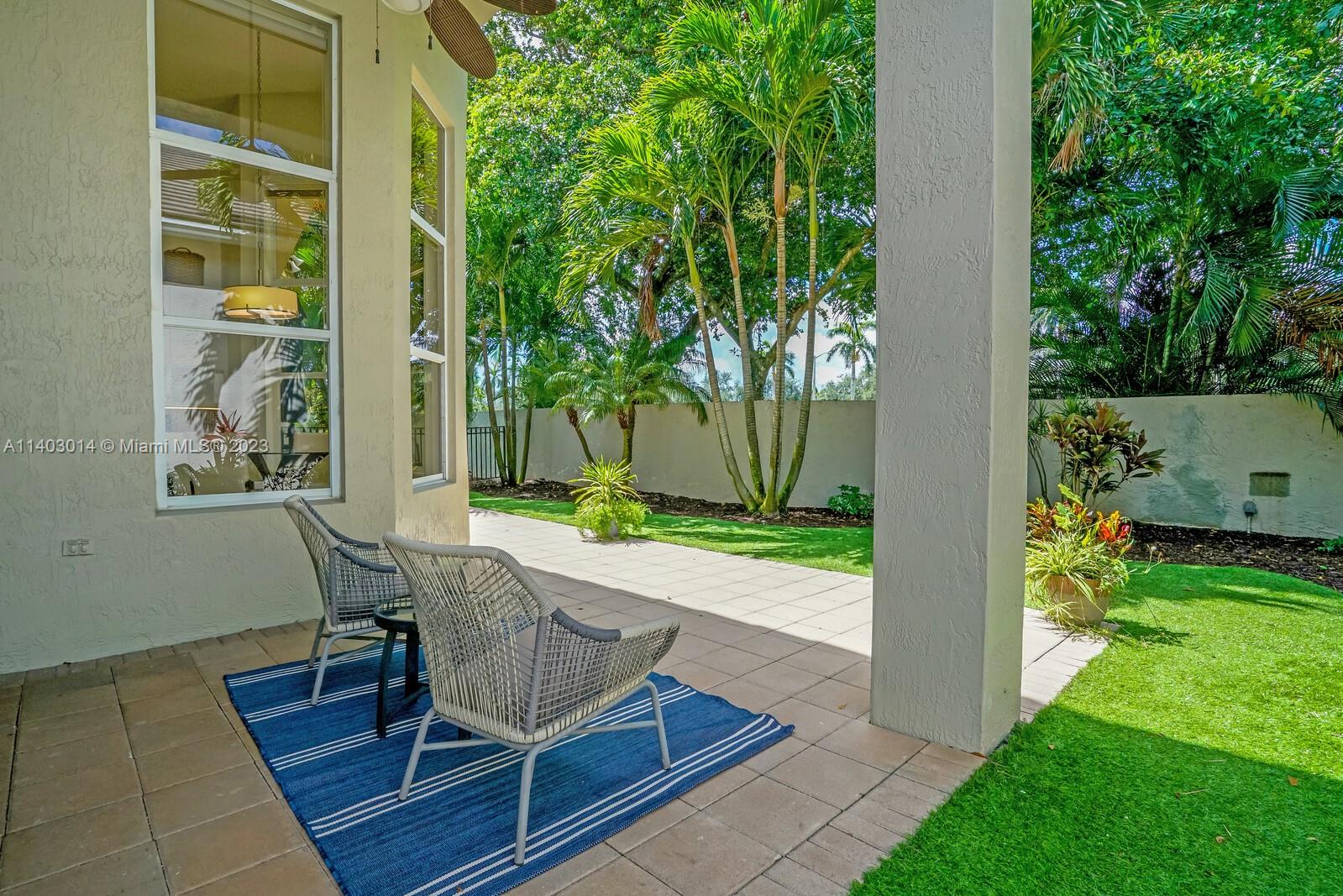 3322 Northwest 53rd Circle Boca Raton, FL 33496 - Photo 28 of 45 a view of a patio with table and chairs and potted plants