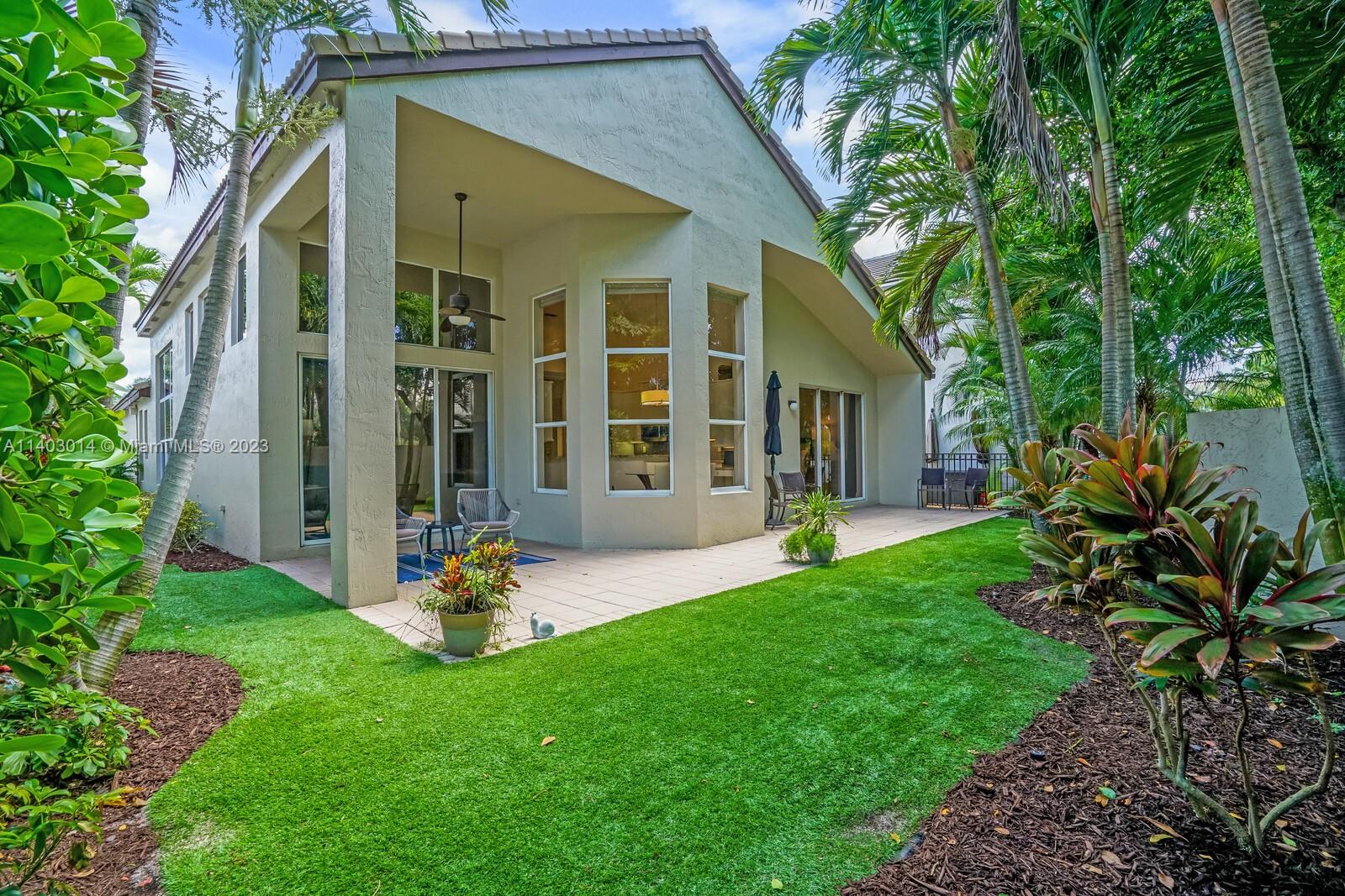 3322 Northwest 53rd Circle Boca Raton, FL 33496 - Photo 29 of 45 a front view of a house with a yard and porch