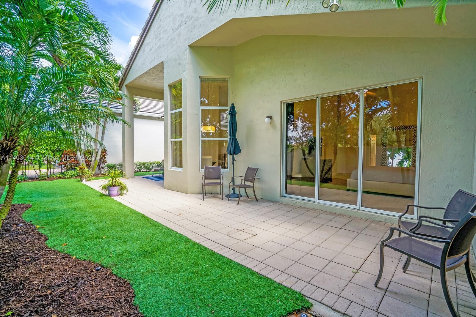 3322 Northwest 53rd Circle Boca Raton, FL 33496 - Photo 31 of 45 a backyard of a house with seating space