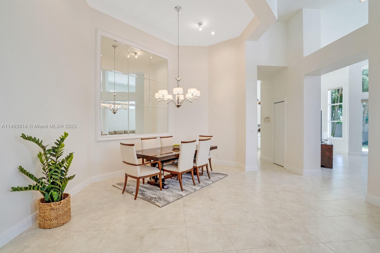3322 Northwest 53rd Circle Boca Raton, FL 33496 - Photo 4 of 45 a view of a dining room with furniture and chandelier