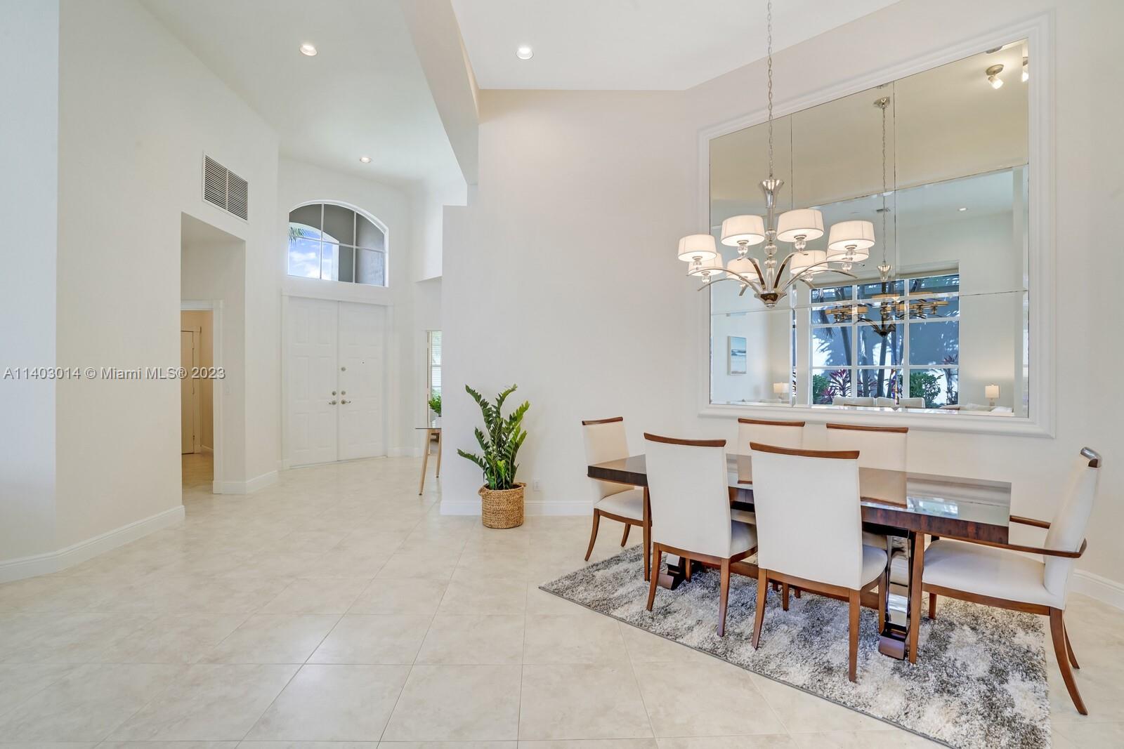3322 Northwest 53rd Circle Boca Raton, FL 33496 - Photo 6 of 45 a dining room with furniture and chandelier