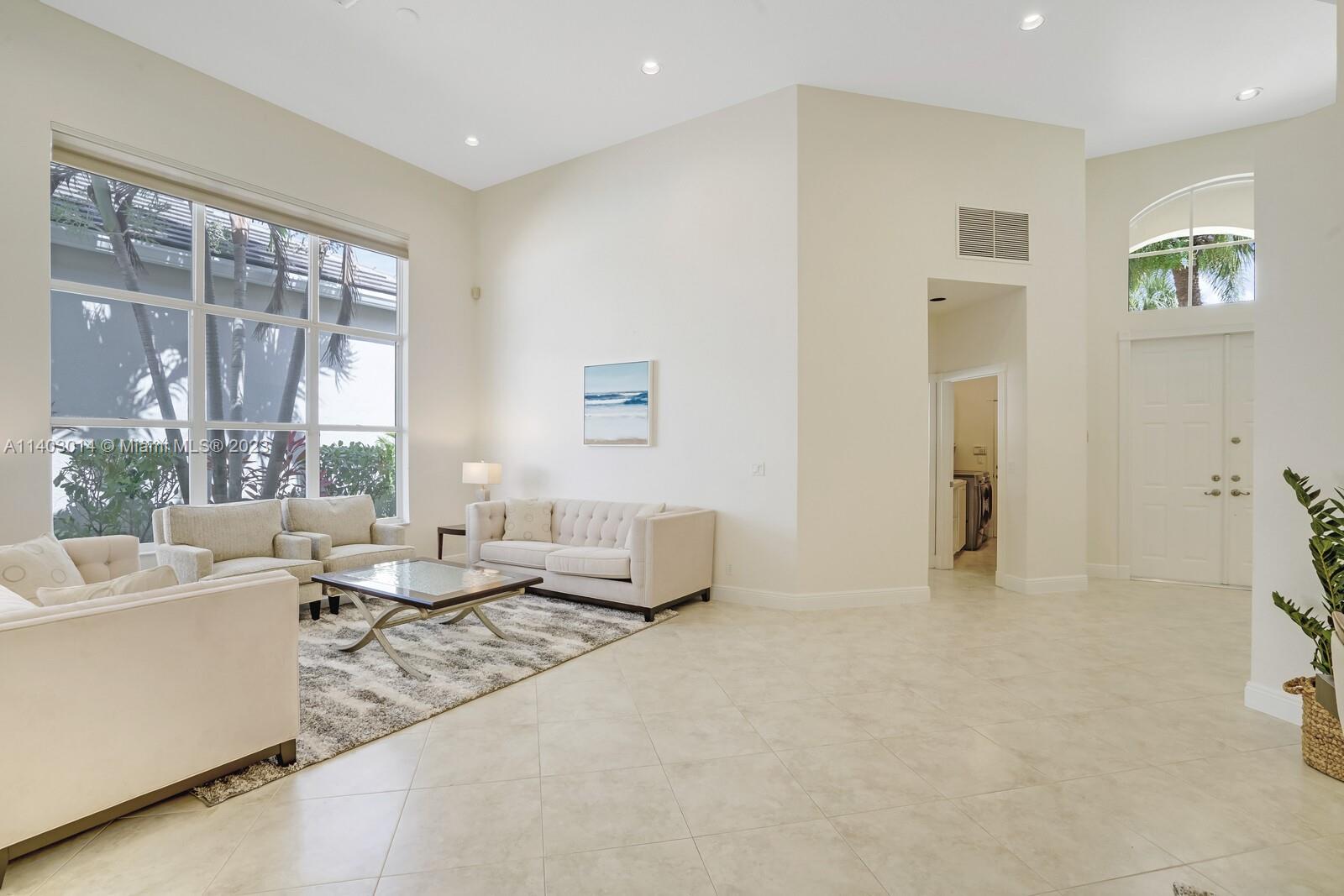 3322 Northwest 53rd Circle Boca Raton, FL 33496 - Photo 7 of 45 a living room with furniture and a large window