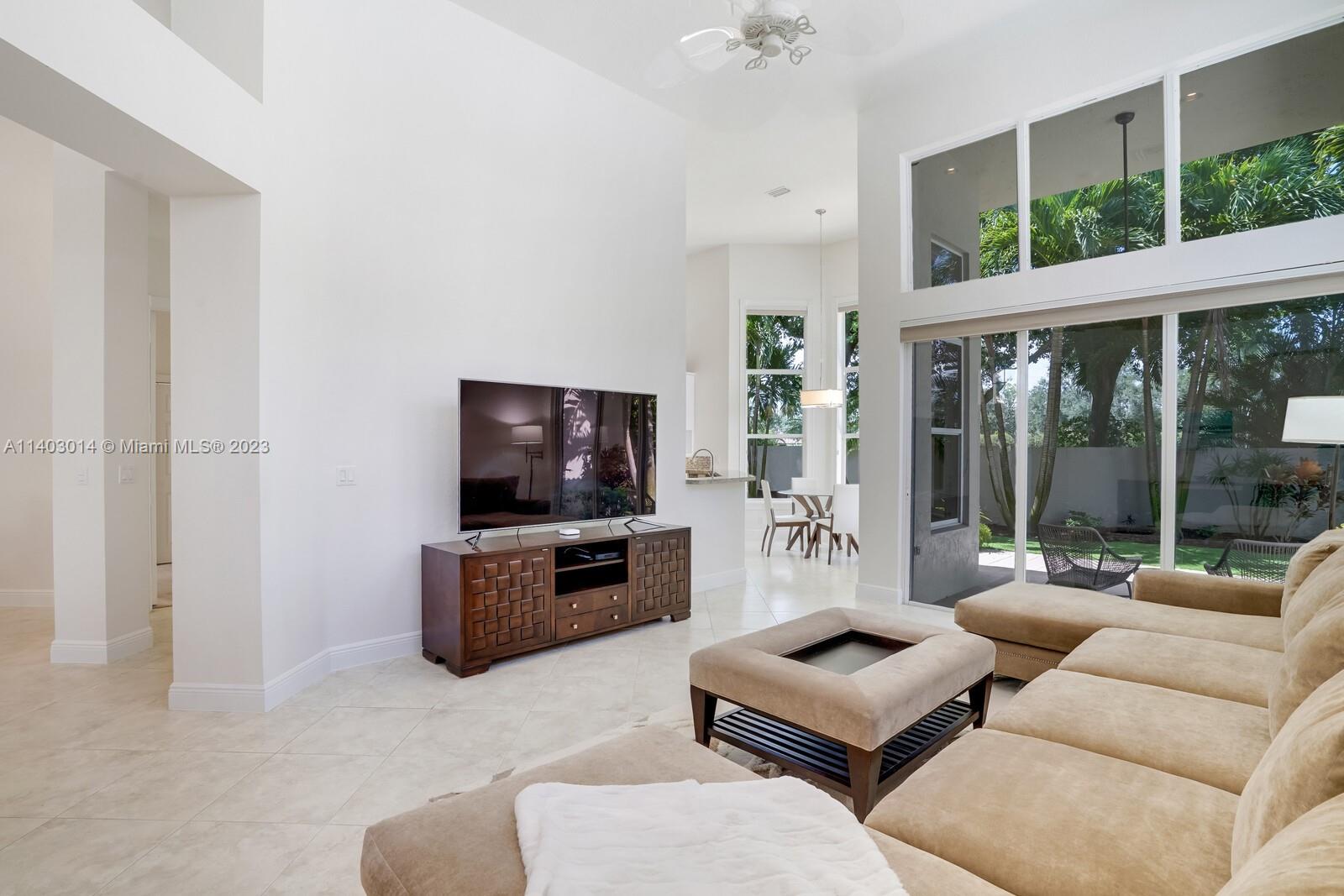 3322 Northwest 53rd Circle Boca Raton, FL 33496 - Photo 10 of 45 a living room with furniture and a flat screen tv
