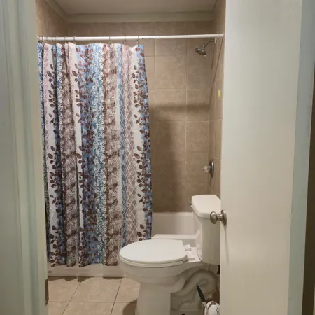 a bathroom with a toilet and shower