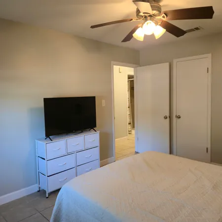 a bedroom with a bed and a flat screen tv