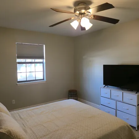 a bedroom with a bed and a flat screen tv