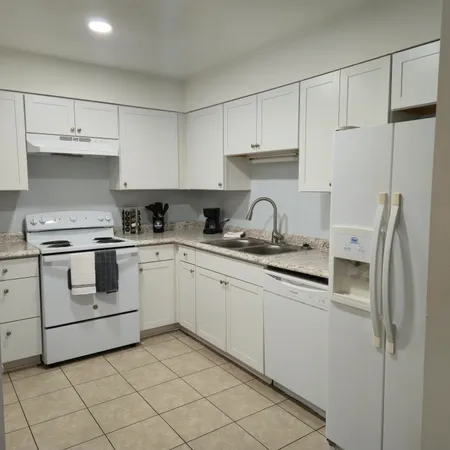 a kitchen with cabinets appliances and a sink