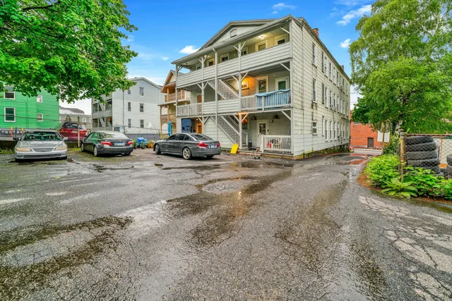 a view of a cars park in front of a building