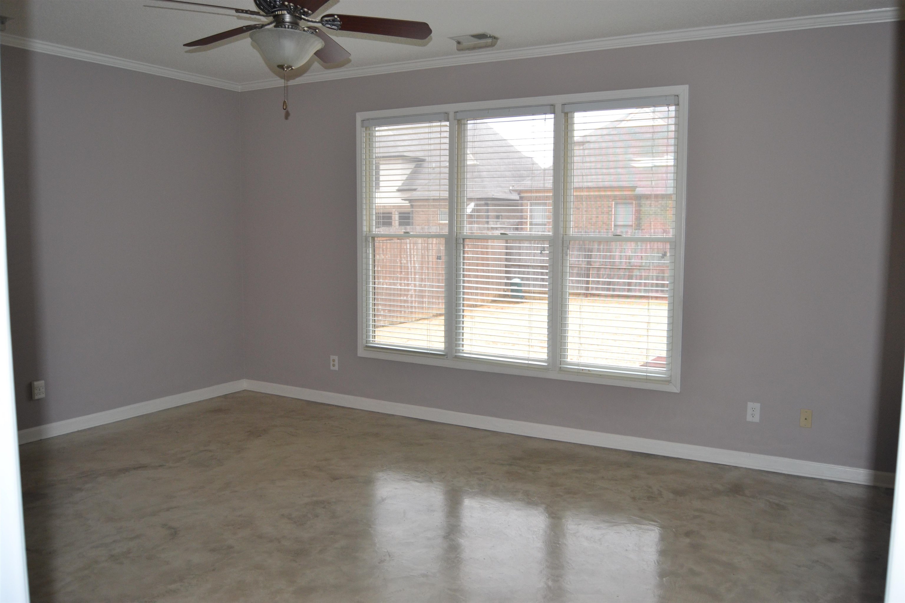 10486 Juneau Way Collierville, TN 38017 - Photo 11 of 33 Spare room with a wealth of natural light, crown molding, ceiling fan, and concrete flooring