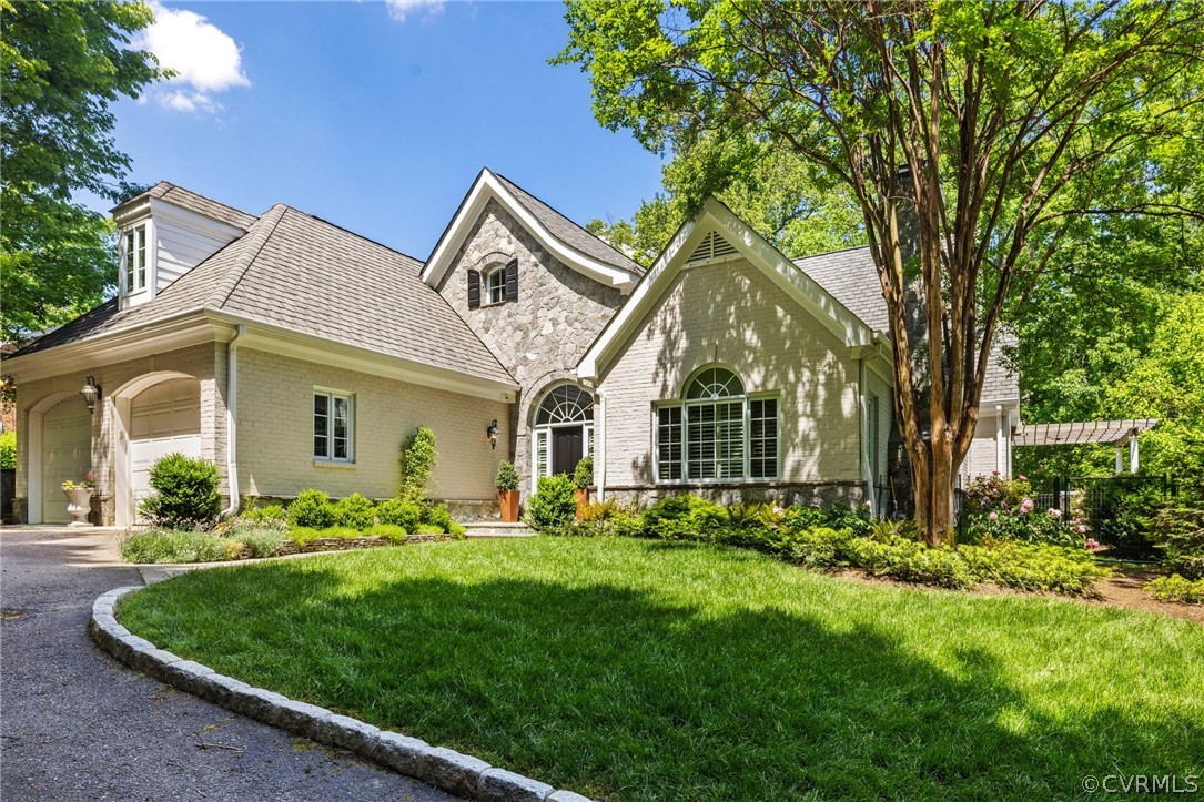 7215 Riverside Drive Richmond, VA 23225 - Photo 2 of 42 a front view of a house with a garden