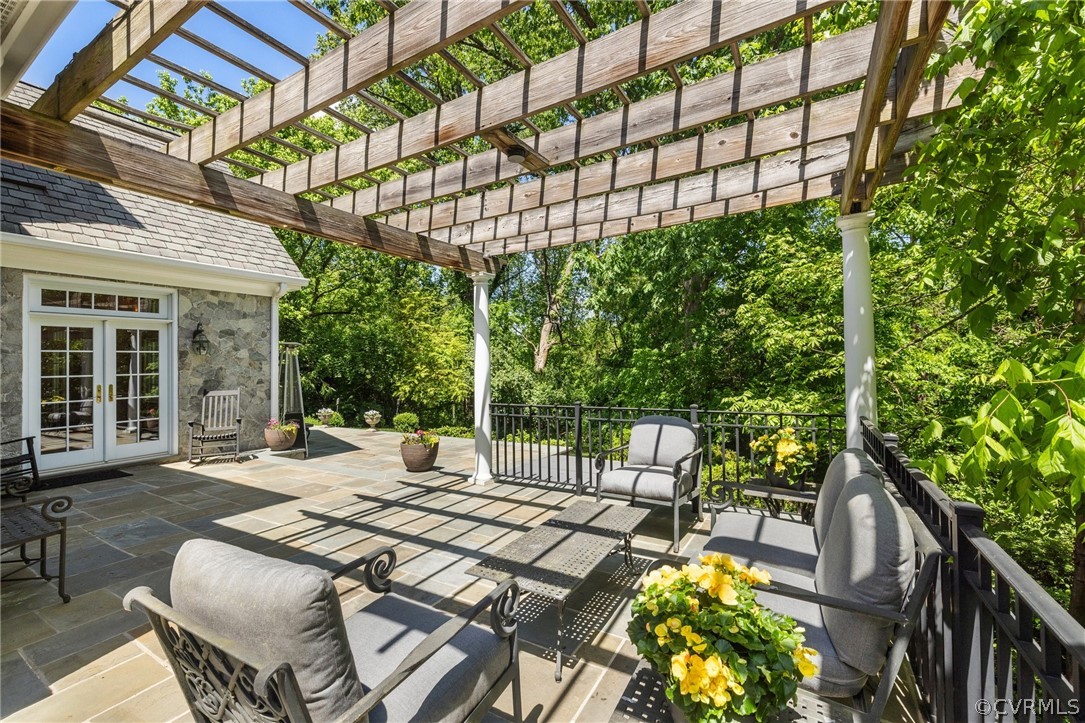 7215 Riverside Drive Richmond, VA 23225 - Photo 36 of 42 a view of a patio with table and chairs potted plants with wooden floor and fence