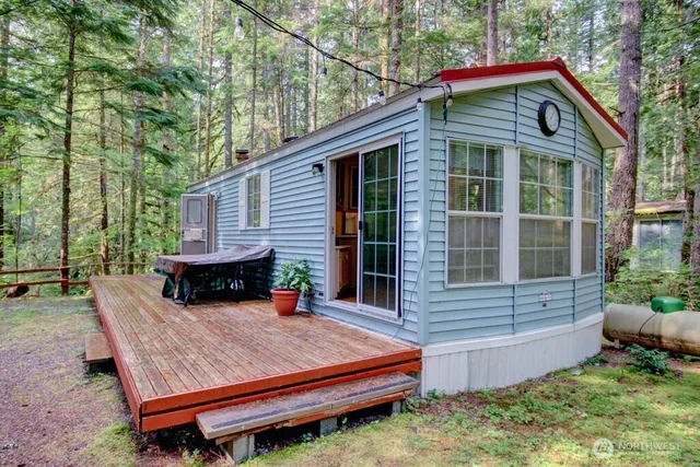 a view of a wooden chairs and bench in the backyard
