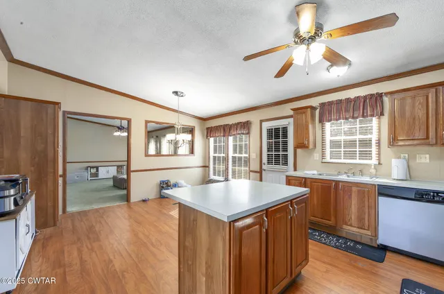 a kitchen with refrigerator cabinets and wooden floor