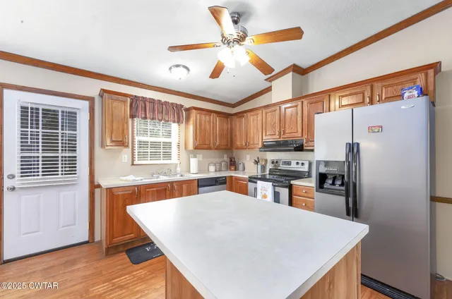 a utility room with dryer washer and a kitchen view