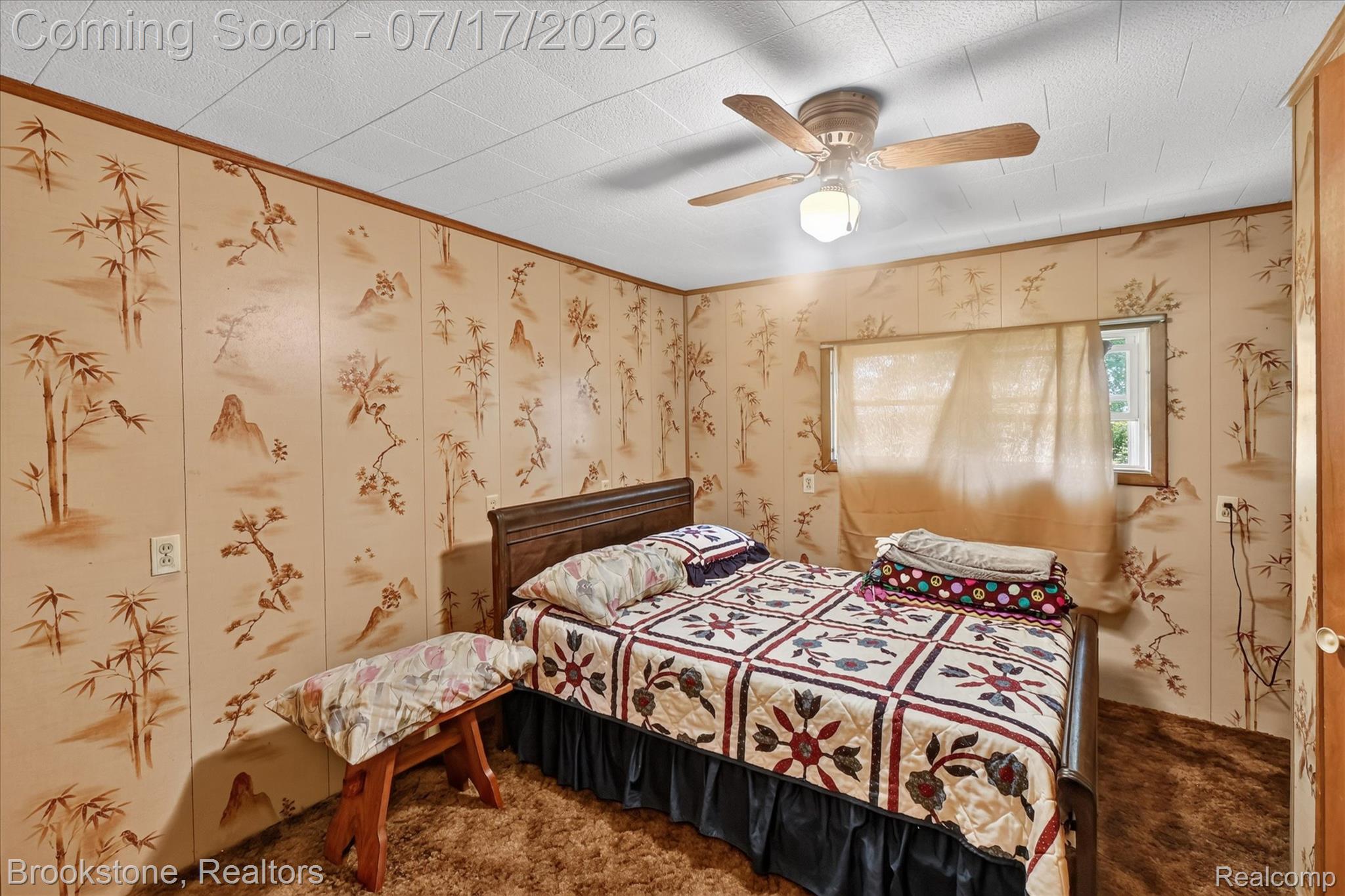 22025 Lakefield Road Merrill, MI 48637 - Photo 24 of 47 Bedroom featuring patterned wall paneling, a ceiling fan with light kit, a single window, and textured carpet flooring