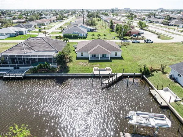 an aerial view of residential houses with outdoor space and river