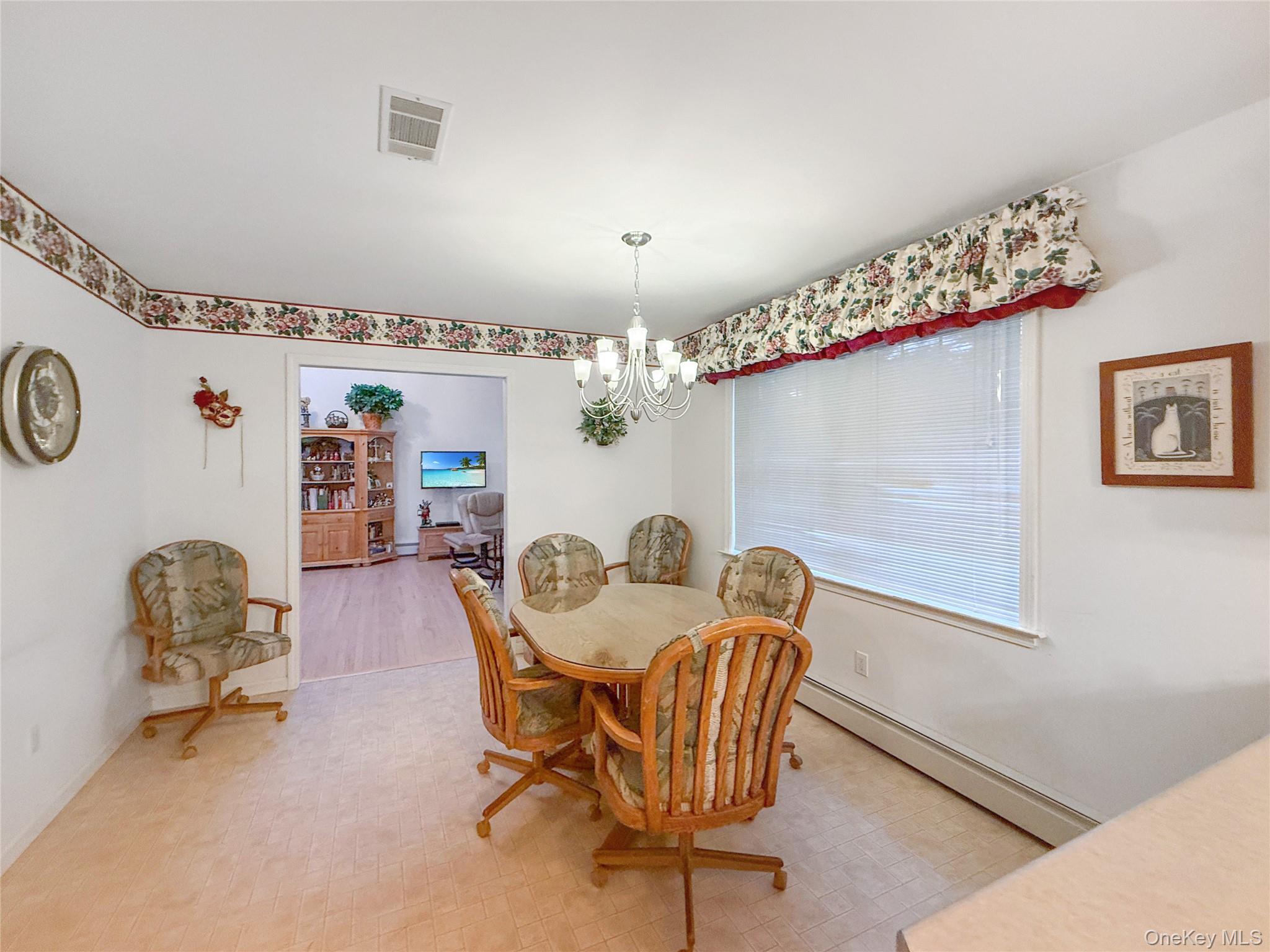 34 Feiertag Road Middletown, NY 10941 - Photo 15 of 28 Dining space with a baseboard radiator and a chandelier