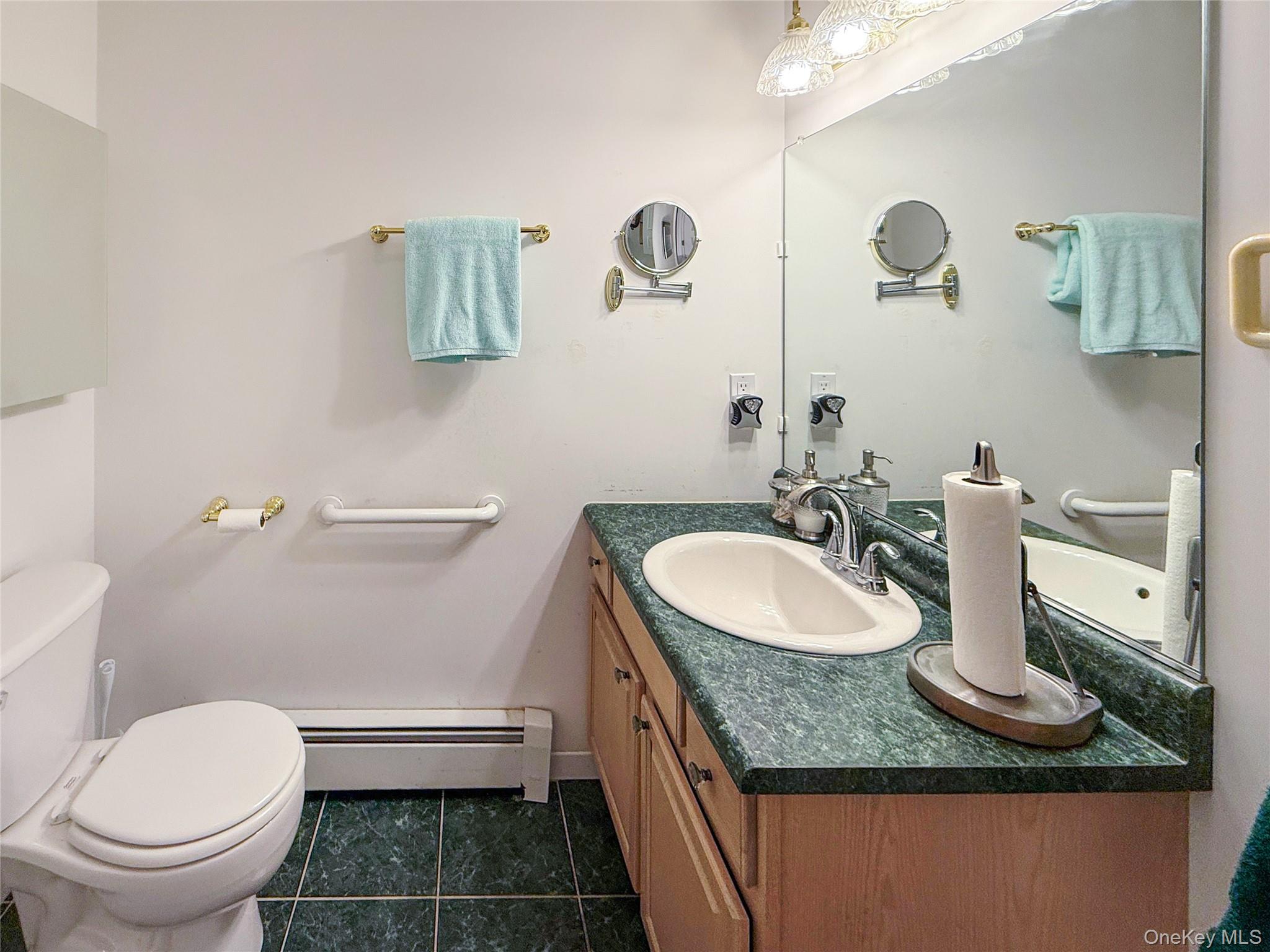 34 Feiertag Road Middletown, NY 10941 - Photo 19 of 28 Bathroom featuring a baseboard radiator, vanity, and tile patterned floors
