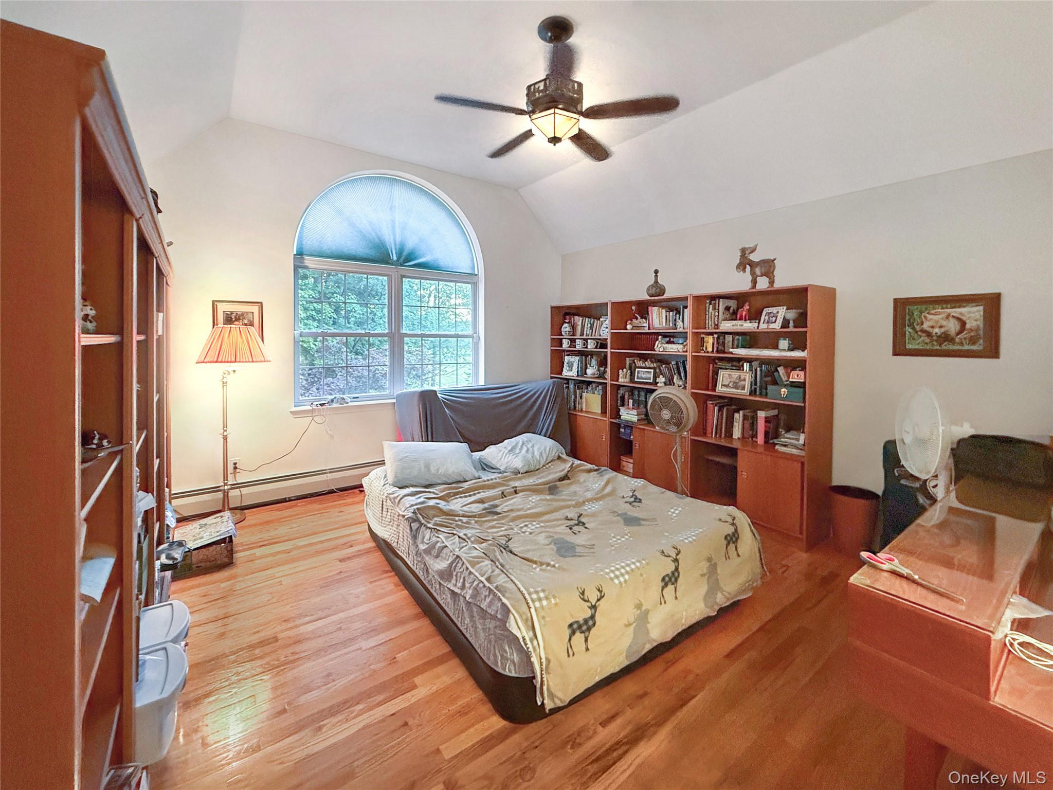 34 Feiertag Road Middletown, NY 10941 - Photo 26 of 28 Bedroom with lofted ceiling, a baseboard heating unit, wood finished floors, and ceiling fan