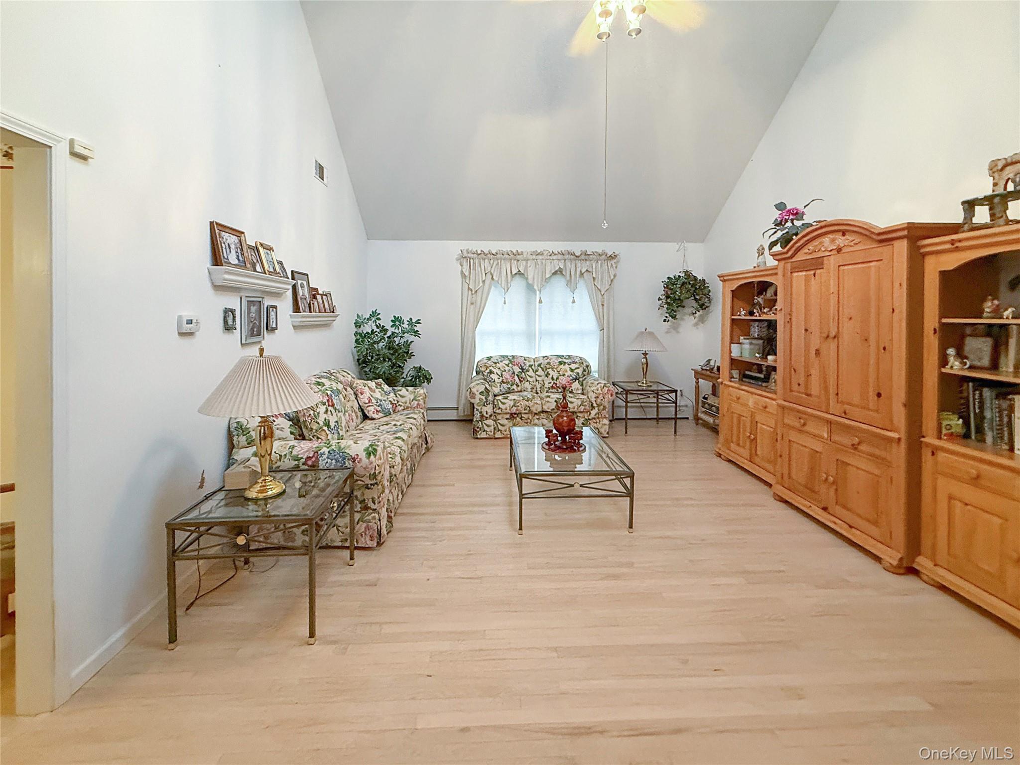34 Feiertag Road Middletown, NY 10941 - Photo 10 of 28 Living area with high vaulted ceiling, light wood-type flooring, and ceiling fan