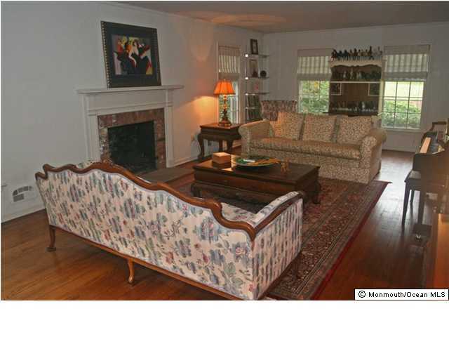 16 Ramsey Road Middletown, NJ 07748 - Photo 3 of 3 a living room with furniture and a fireplace