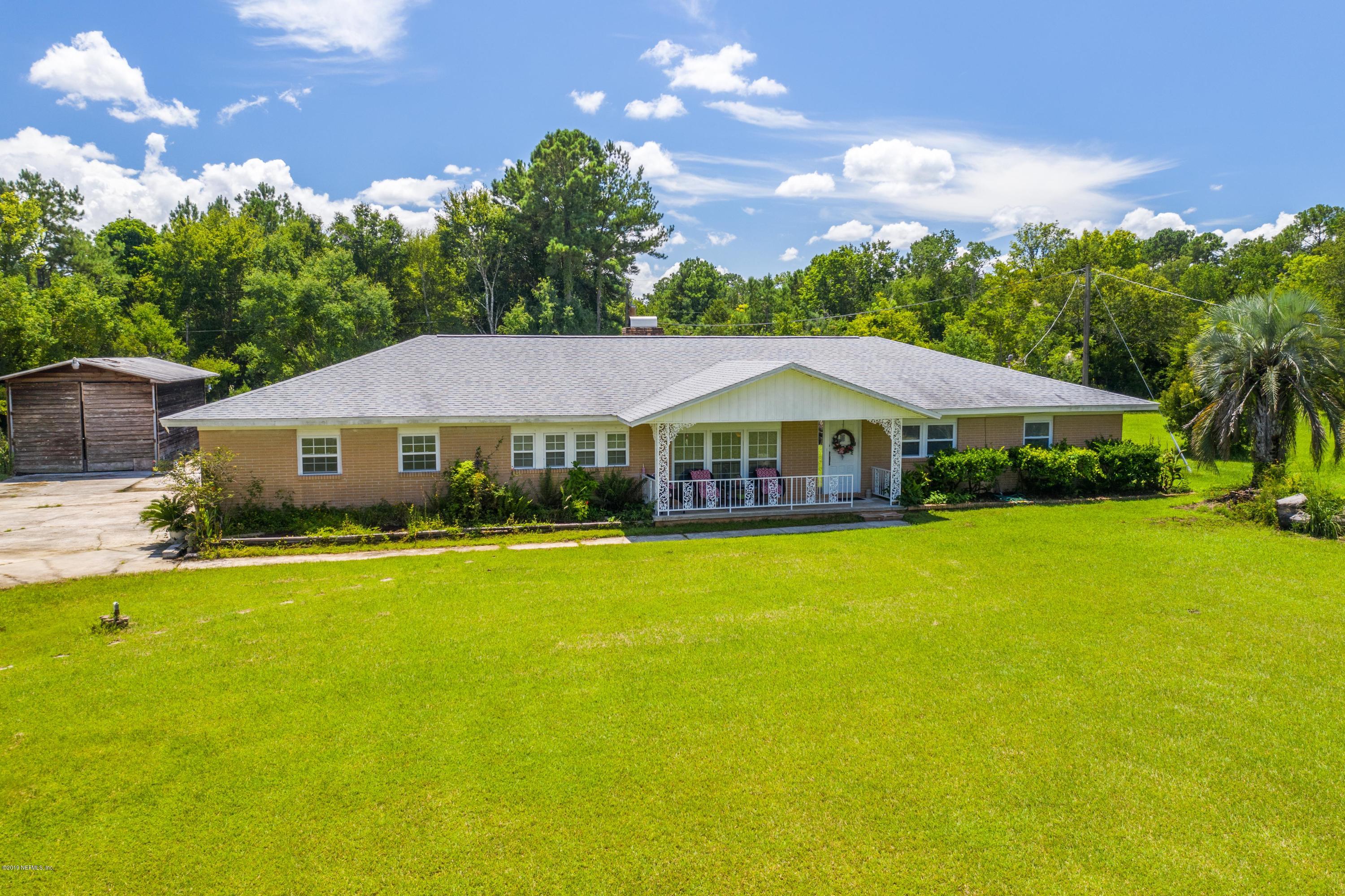 54152 Snyder Road Callahan, FL 32011 - Photo 1 of 39 a front view of a house with yard and swimming pool