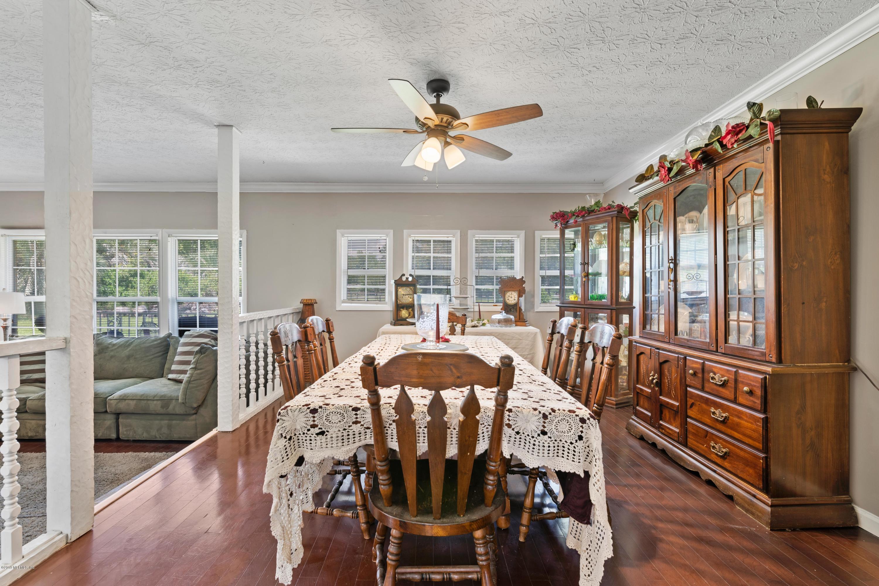 54152 Snyder Road Callahan, FL 32011 - Photo 14 of 39 a view of a dining room with furniture window and wooden floor