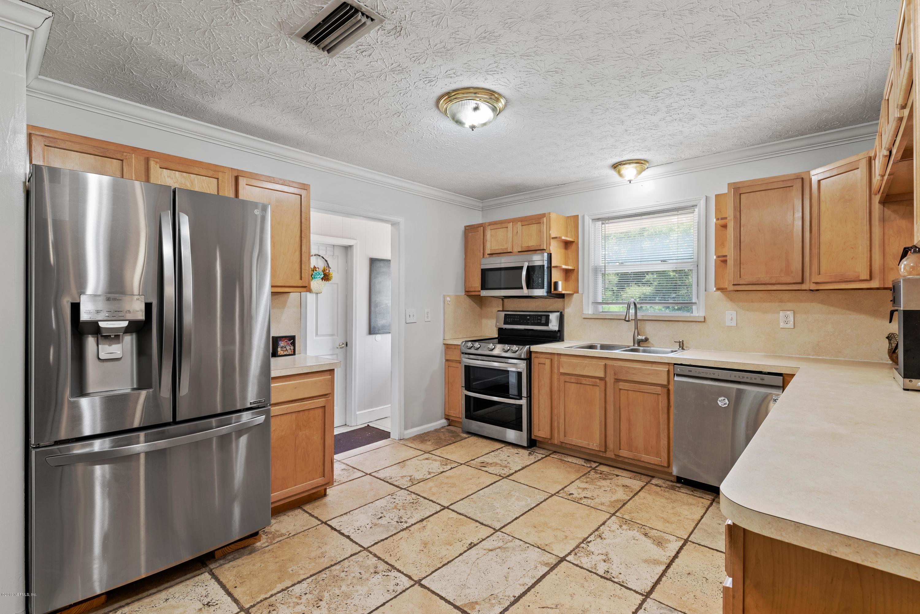54152 Snyder Road Callahan, FL 32011 - Photo 15 of 39 a kitchen with granite countertop stainless steel appliances a refrigerator stove top oven and sink