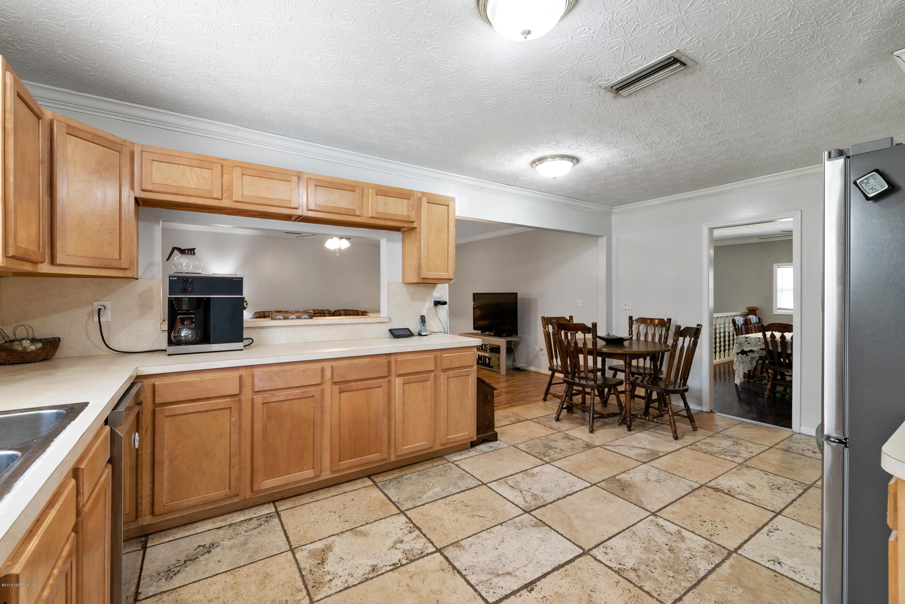 54152 Snyder Road Callahan, FL 32011 - Photo 16 of 39 a kitchen with cabinets and chairs