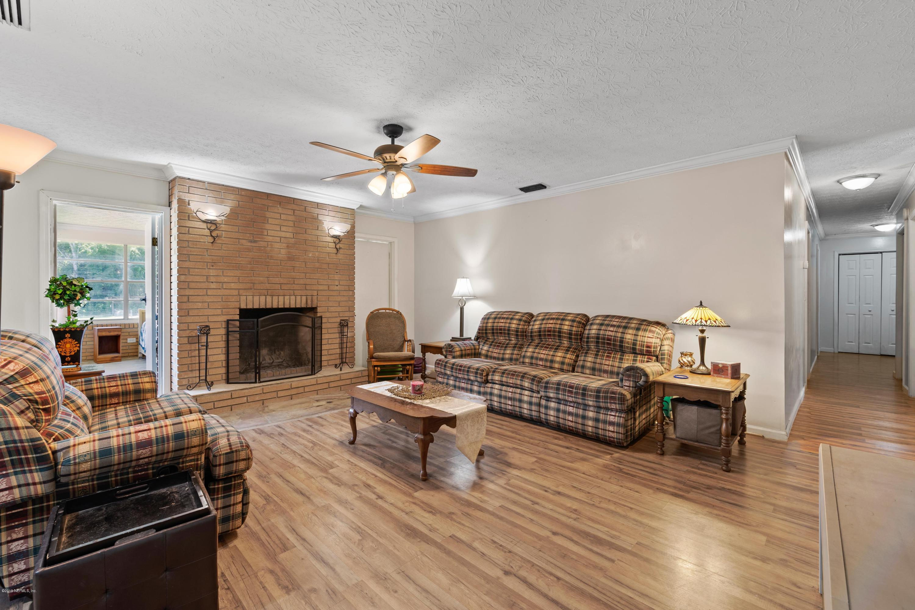 54152 Snyder Road Callahan, FL 32011 - Photo 18 of 39 a living room with furniture and a fireplace