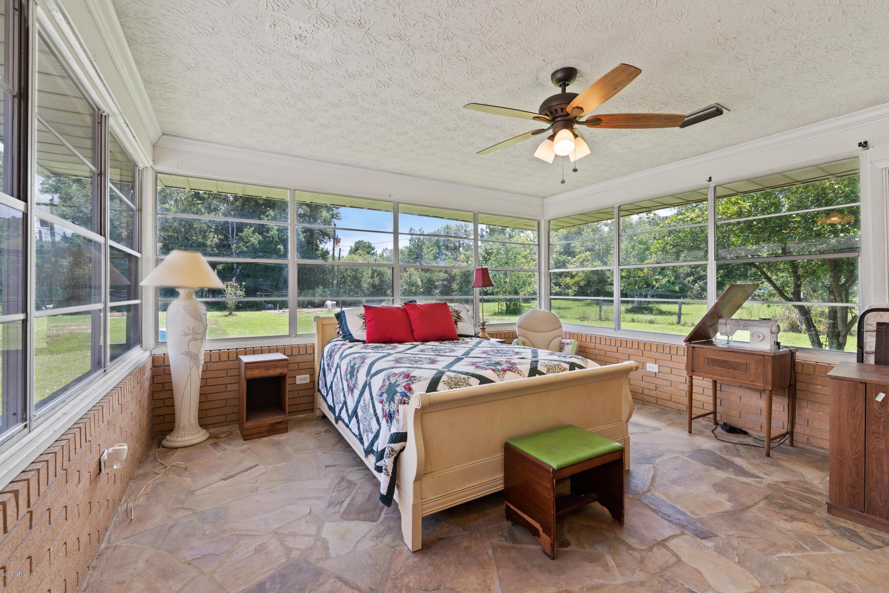 54152 Snyder Road Callahan, FL 32011 - Photo 21 of 39 a bedroom with a bed and a desk