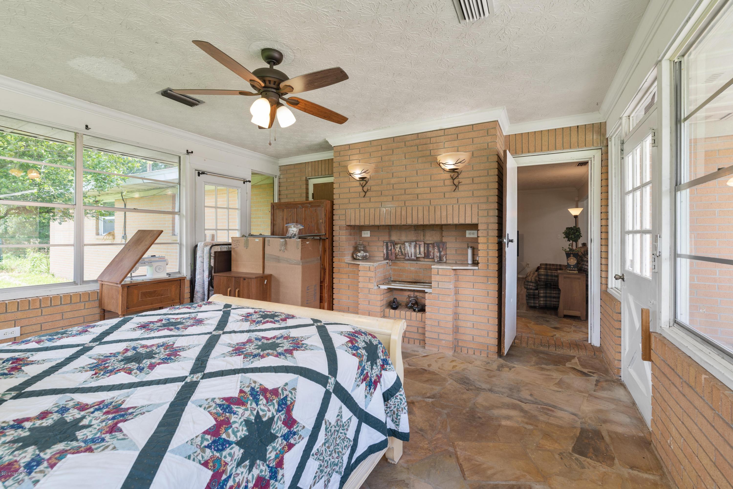 54152 Snyder Road Callahan, FL 32011 - Photo 22 of 39 a very nice looking room with a large window and a chandelier