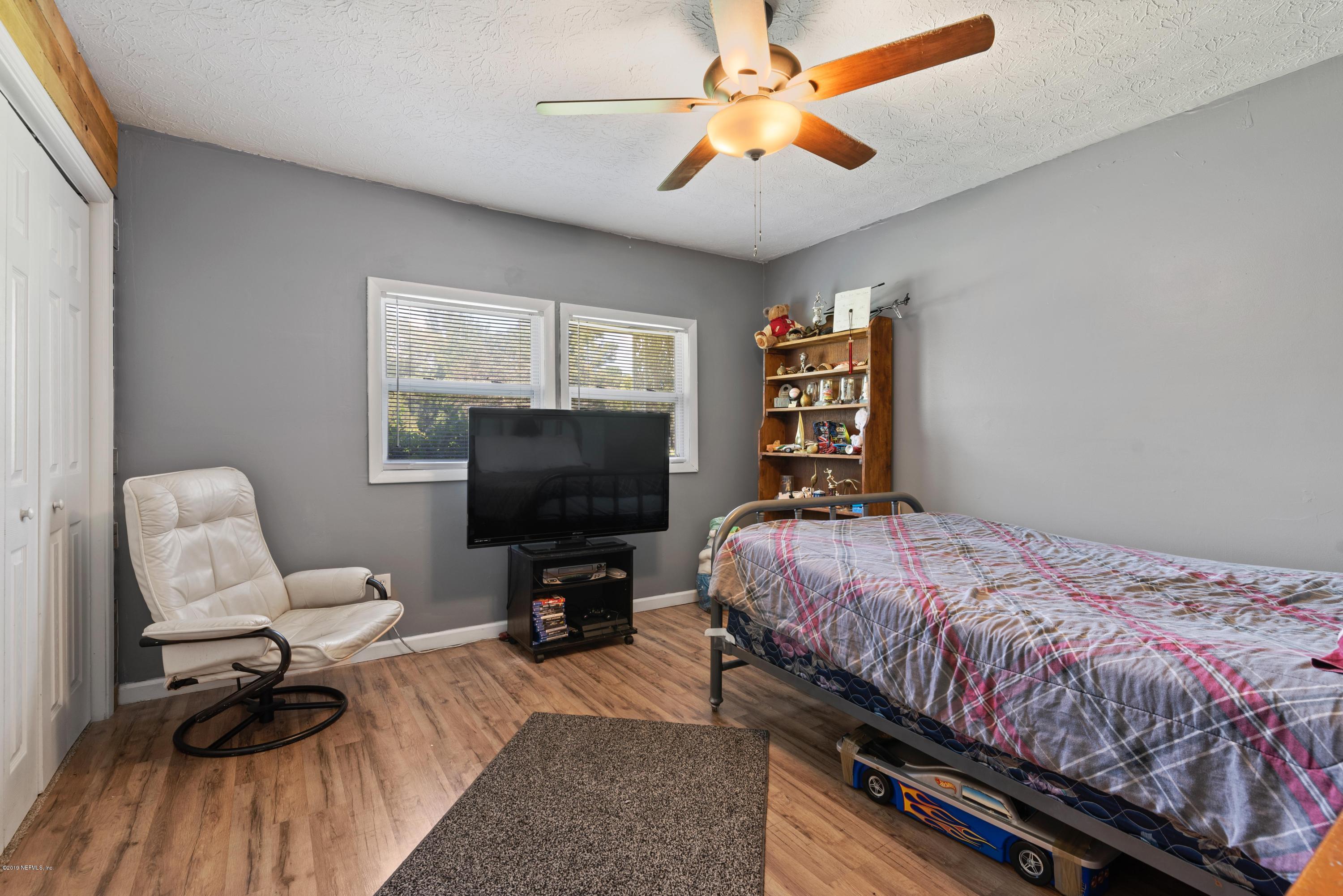 54152 Snyder Road Callahan, FL 32011 - Photo 26 of 39 a bedroom with a bed and a flat screen tv