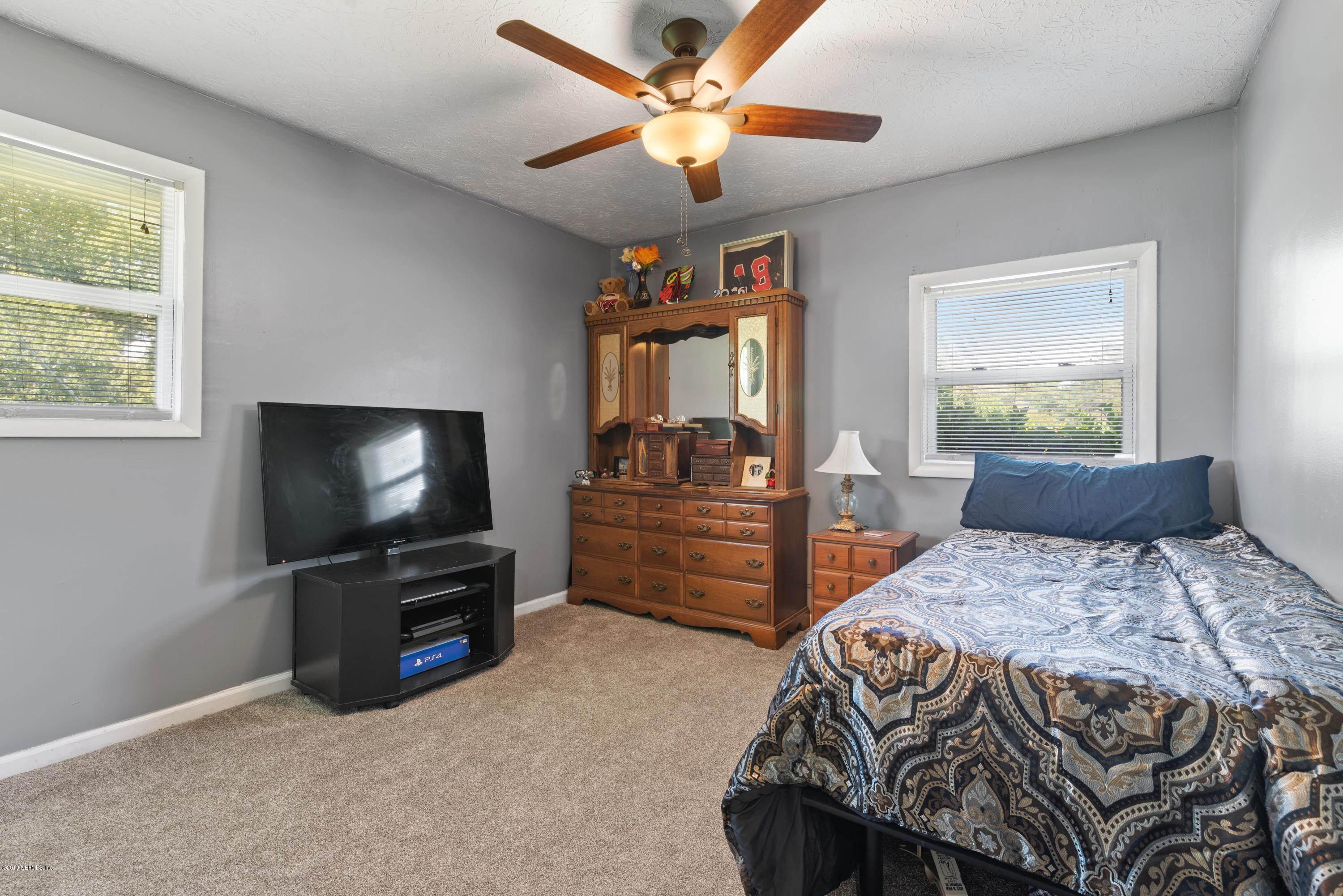 54152 Snyder Road Callahan, FL 32011 - Photo 28 of 39 a bedroom with a bed and a flat screen tv